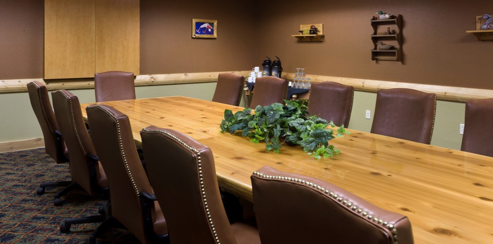 Meeting room with a large table and surrounded by chairs