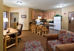 Desk, Chair, and Kitchen area with breakfast bar, fridge, dishwasher, over, and sink