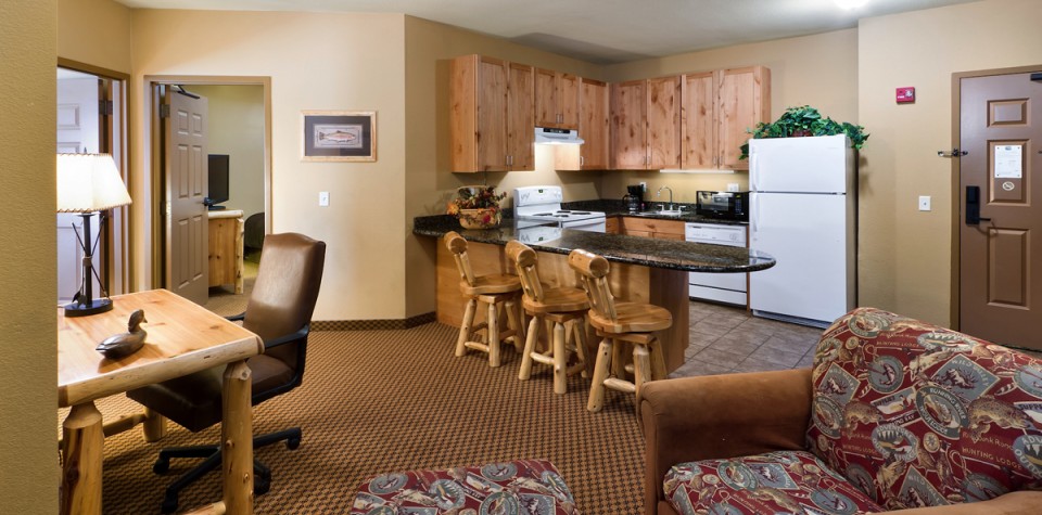 Desk, Chair, and Kitchen area with breakfast bar, fridge, dishwasher, over, and sink